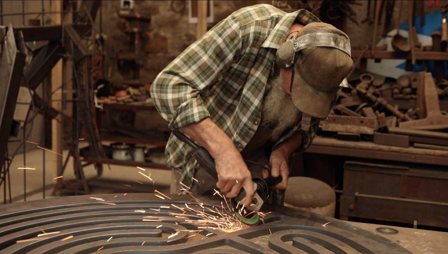 Sparks flying from The Heart of Kerdroya Sculpture in Thrussells Metal Sculpture Workshop